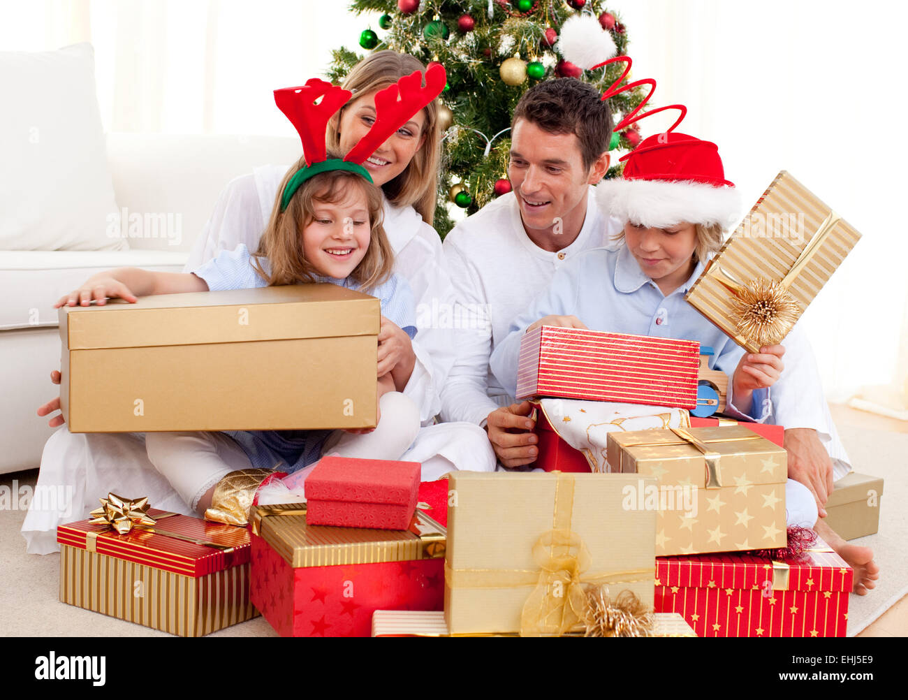Young family having fun with Christmas gifts Stock Photo Alamy