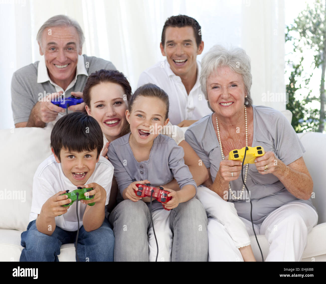 Family having fun playing video games Stock Photo - Alamy