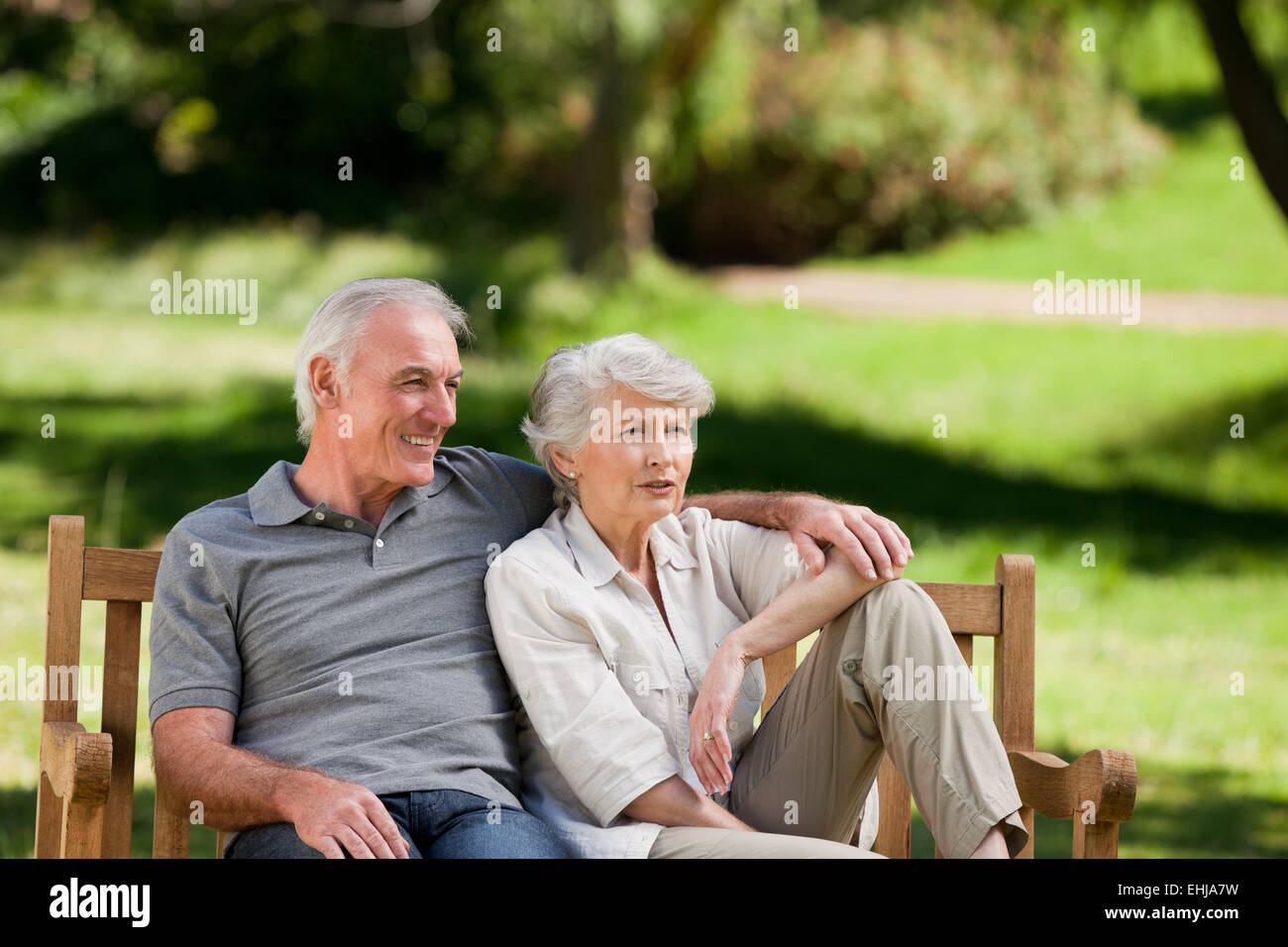 Senior couple sitting on a bench Stock Photo - Alamy