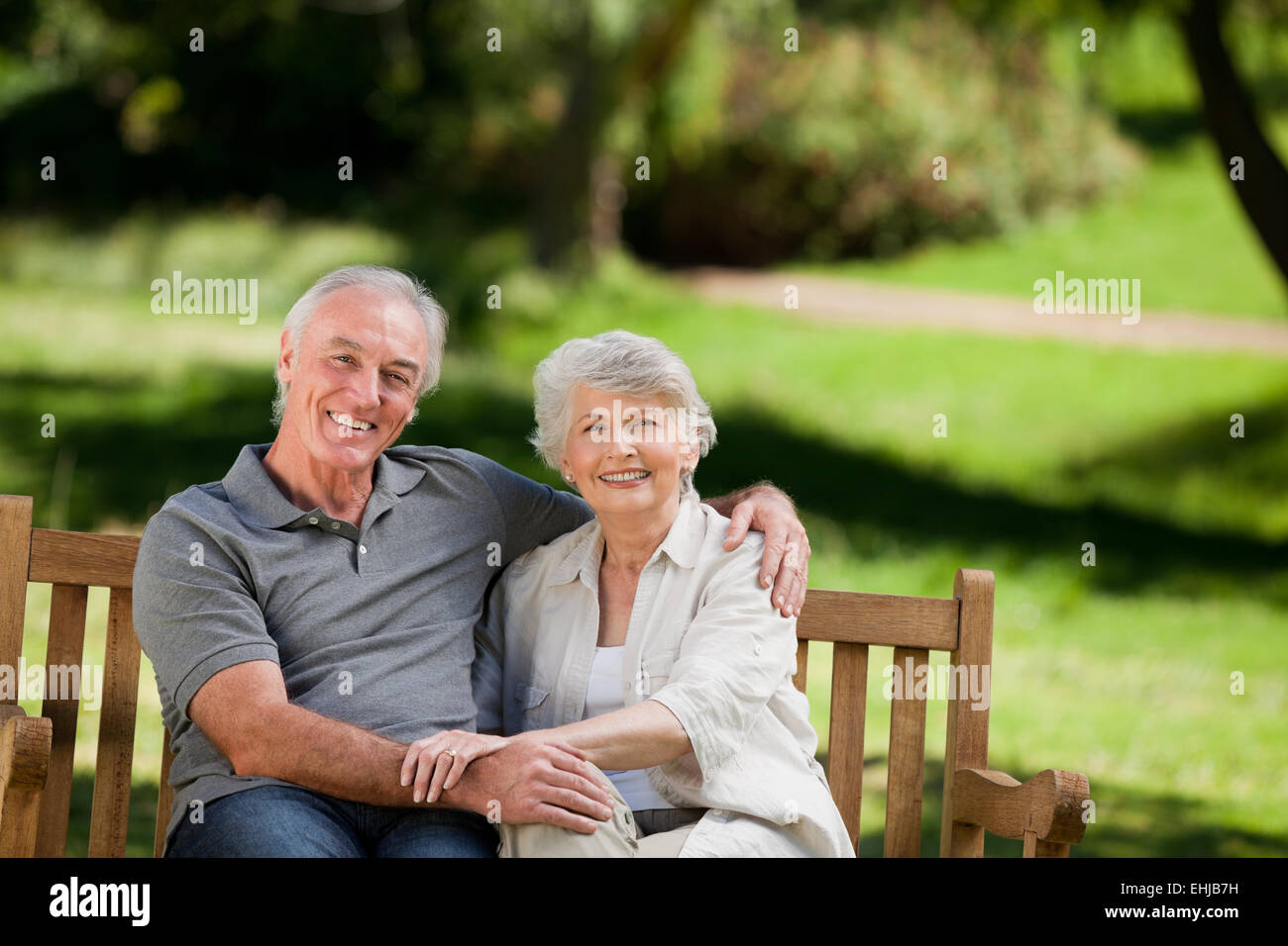 Senior couple sitting on a bench Stock Photo - Alamy