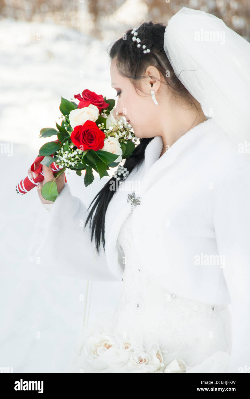 Portrait of the bride with a bunch of flowers, in a wedding dress Stock Photo