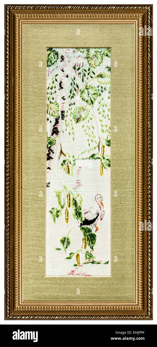 Embroidered picture in the frame, isolated on white background Stock