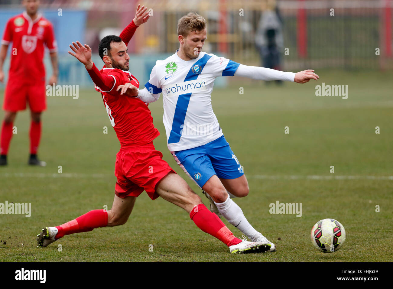 BUDAPEST, HUNGARY - MARCH 14, 2015: Daniel Vadnai of MTK (r) is tackled by Filipe Oliveira of Videoton during MTK vs. Videoton OTP Bank League football match in Bozsik Stadium. Stock Photo