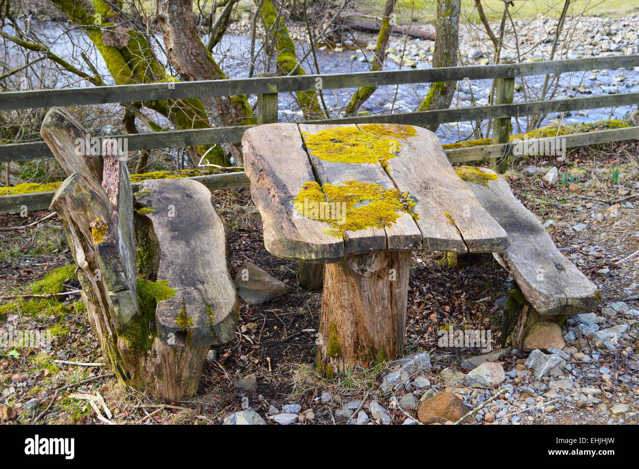Rustic wood picnic bench and seats. Stock Photo