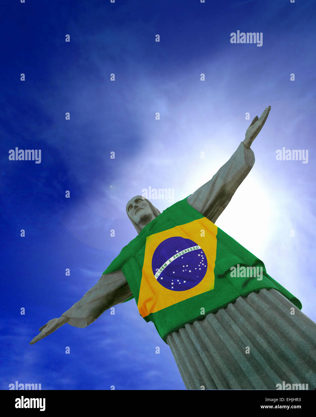 Christ the Redeemer statue at Corcovado, Rio de Janeiro, Brazil.  With Brazilian flag (Bandeira do Brasil). Stock Photo