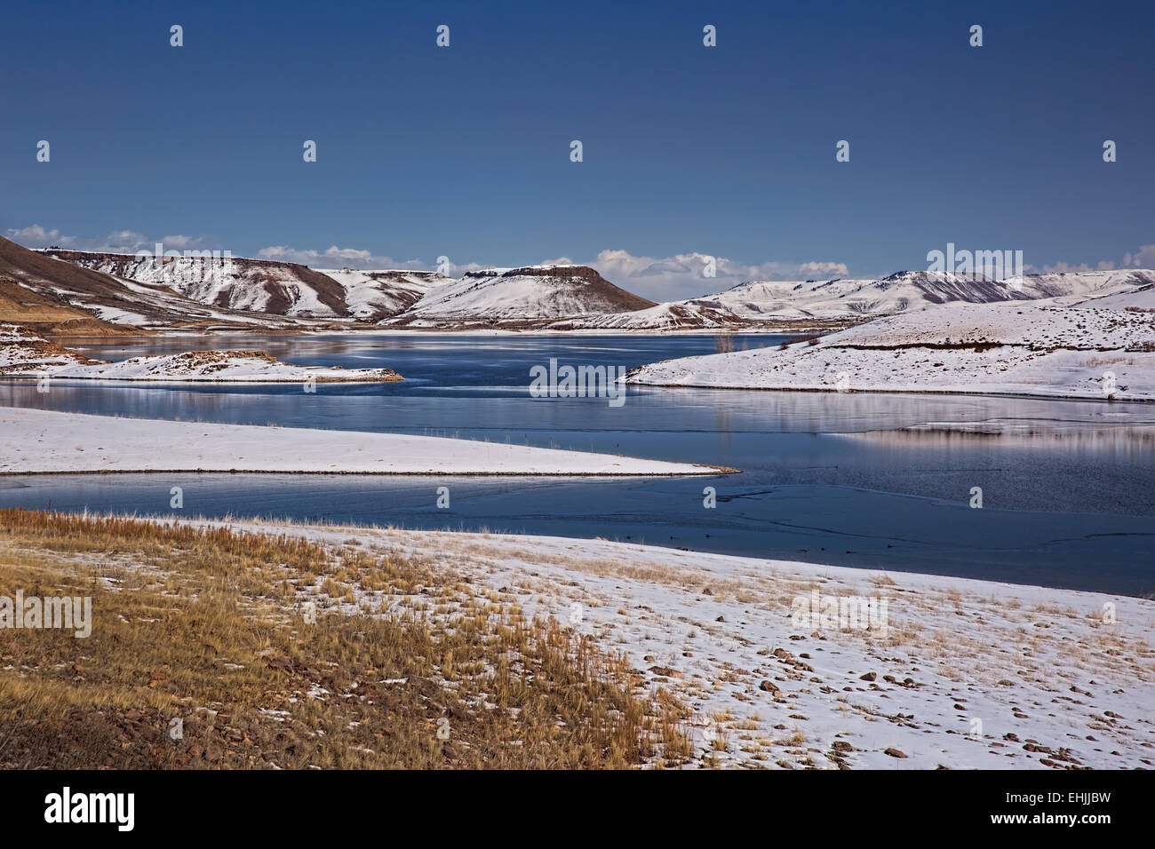 Snowy Mountains surrounding partial frozen Blue Mesa Reservoir near Gunnison Colorado USA Stock Photo