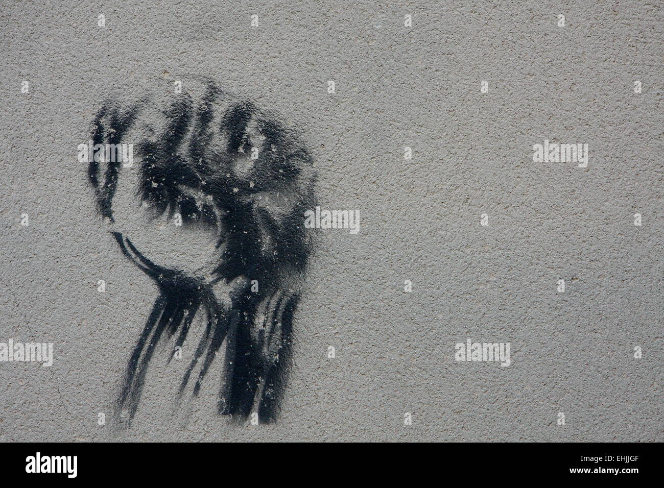 Stencil graffiti with clenched fist Stock Photo