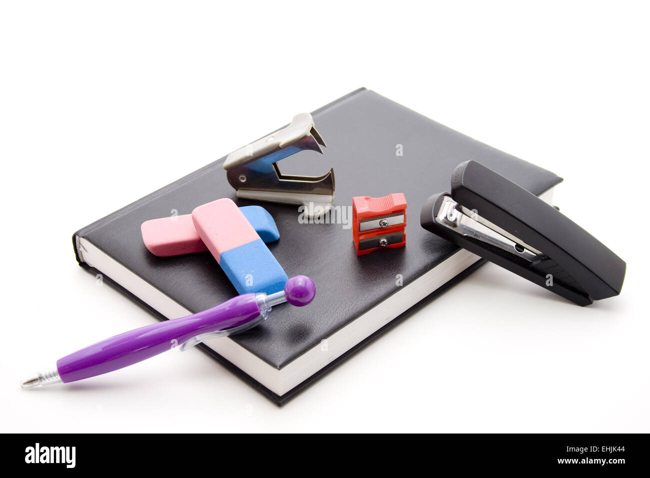 Eraser with sharpener on book Stock Photo - Alamy