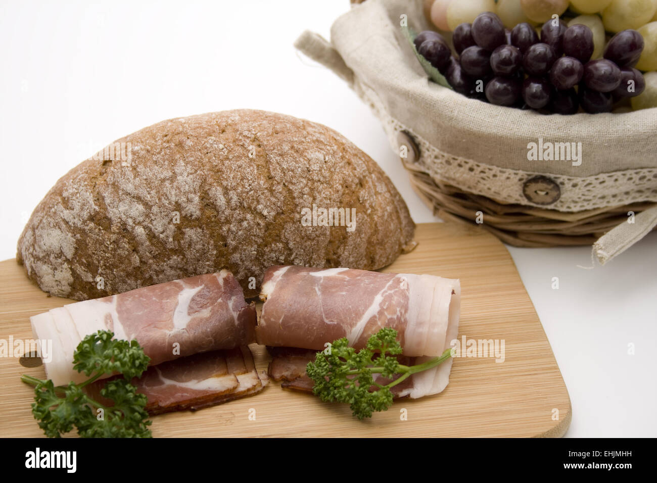 Ham with bread and grapes Stock Photo
