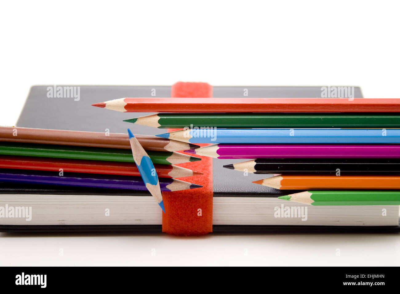 Colored pencils with book Stock Photo