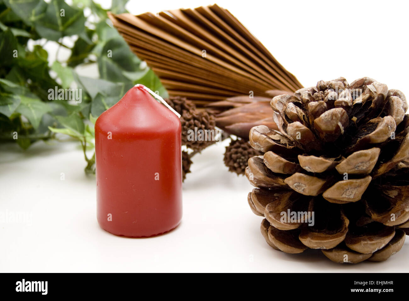 Pine cones and red candle Stock Photo