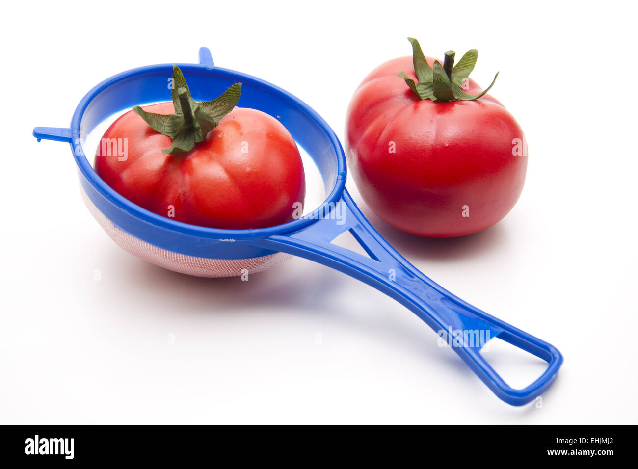 Tomato in the sieve Stock Photo