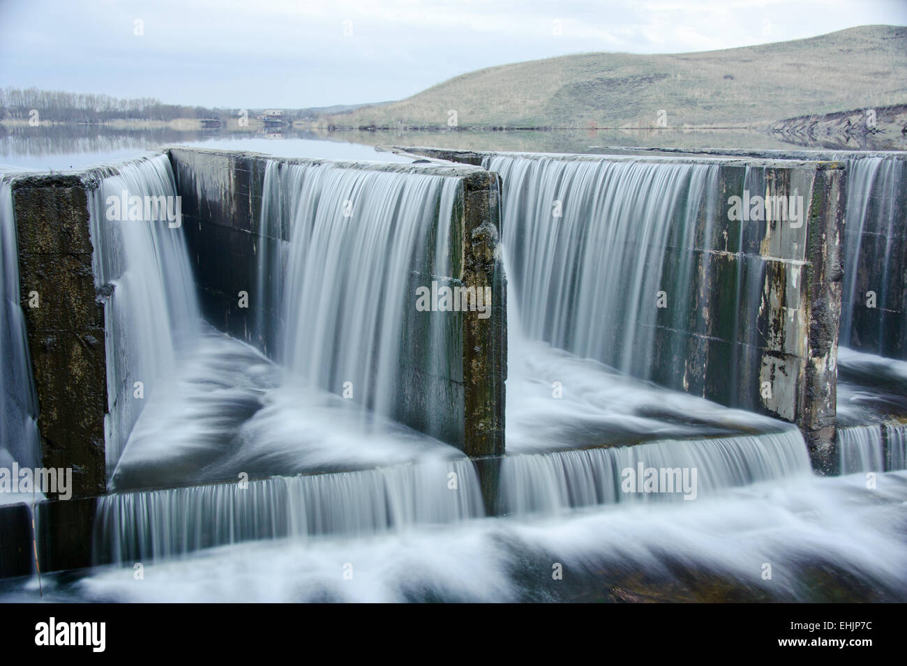 water flowing over a dam Stock Photo