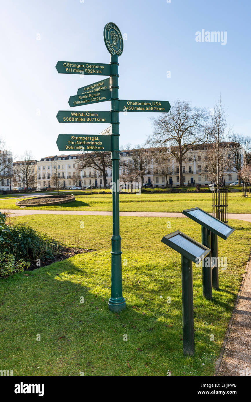 A signpost in the Imperial Gardens of Cheltenham, Gloucestershire pointing to towns which are twinned with Cheltenham worldwide Stock Photo