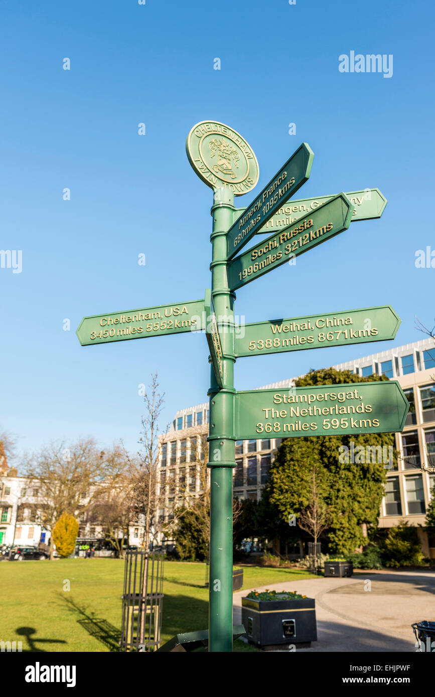 A signpost in the Imperial Gardens of Cheltenham, Gloucestershire pointing to towns which are twinned with Cheltenham worldwide Stock Photo