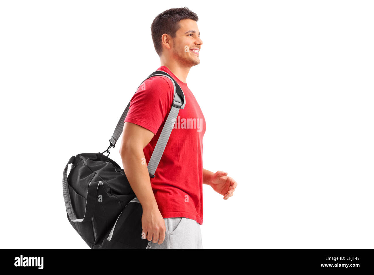 Male athlete walking with a sport bag isolated on white background Stock Photo