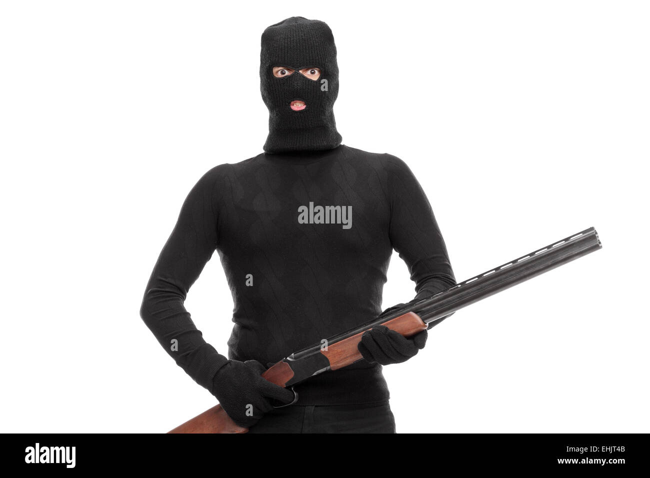 Masked terrorist holding a shotgun isolated on white background Stock Photo