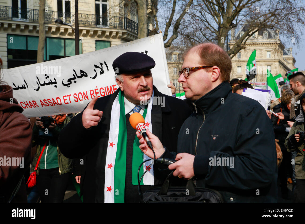 Paris, France. 14th March, 2015. Wael al Hafez, a Syrian activist is interviewed by a journalist from RMC radio Credit:  Estelle des Dorides/Alamy Live News Stock Photo