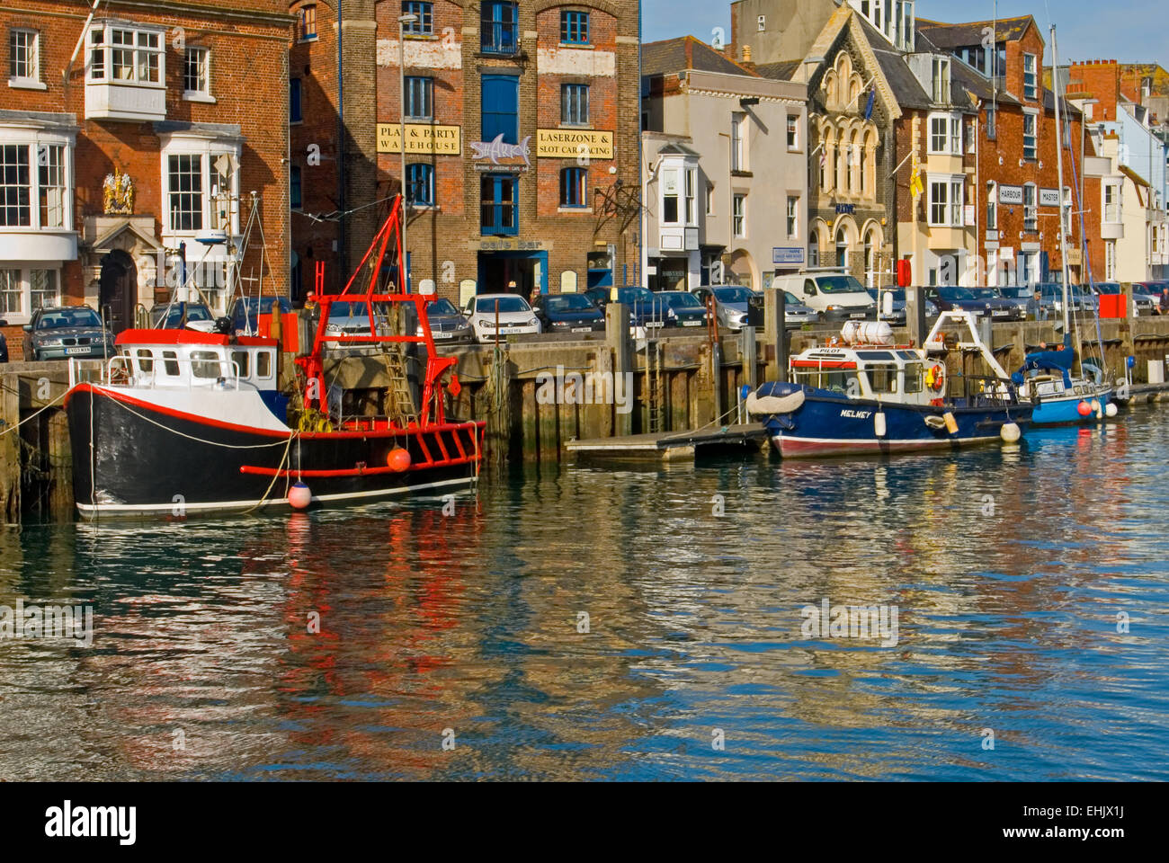 Weymouth Dorset and fishing boats moored to the quayside in the harbour. Stock Photo