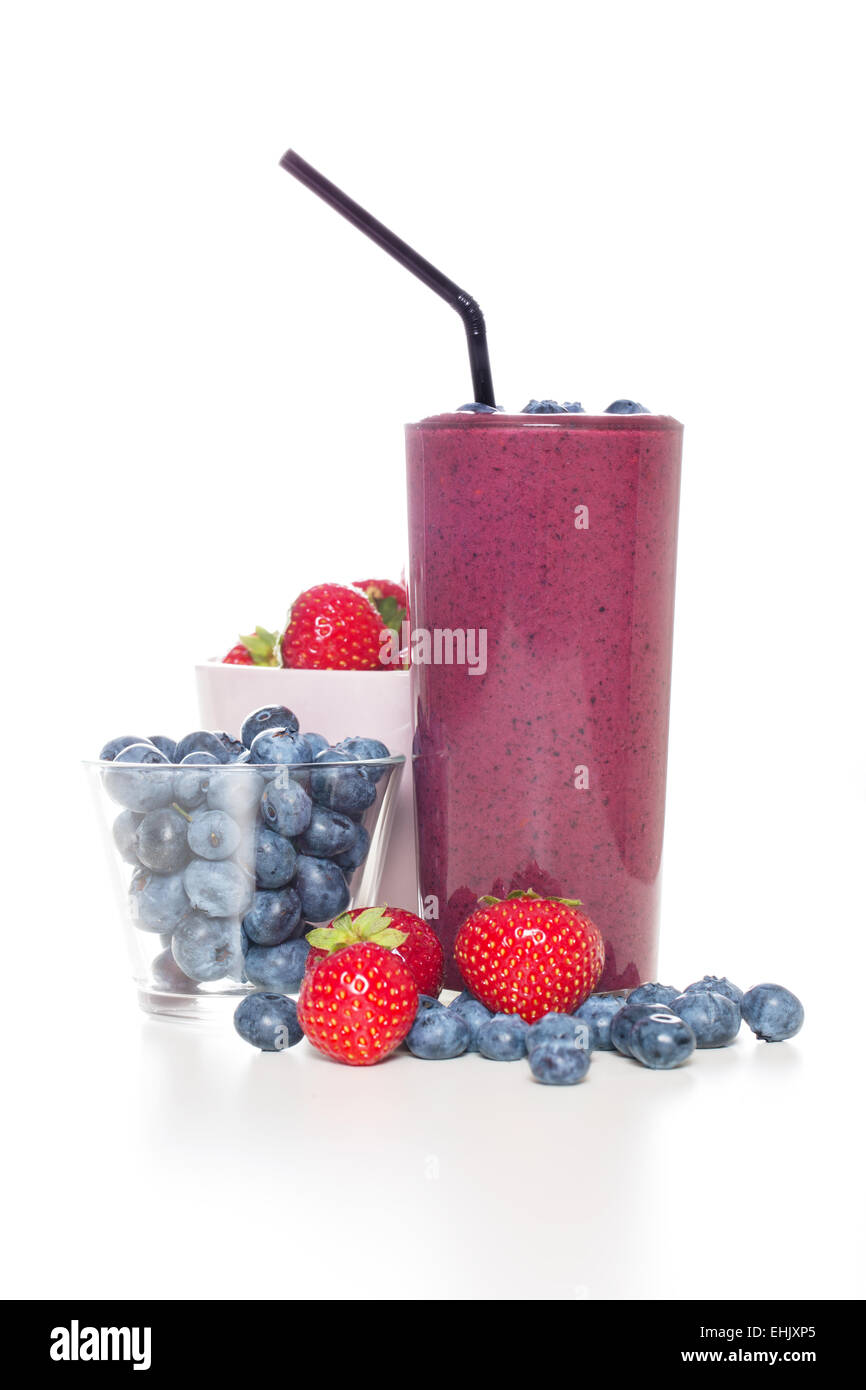 One glass of fresh organic smoothie with straw and blue berries. Stock Photo