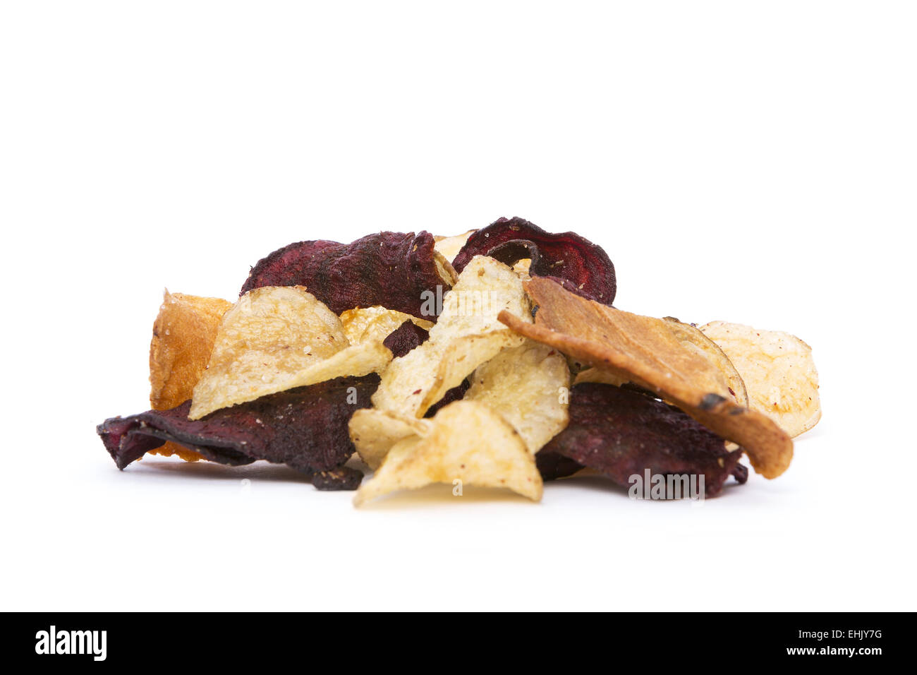 Side view of organic Root Vegetable Chips on white background. Stock Photo