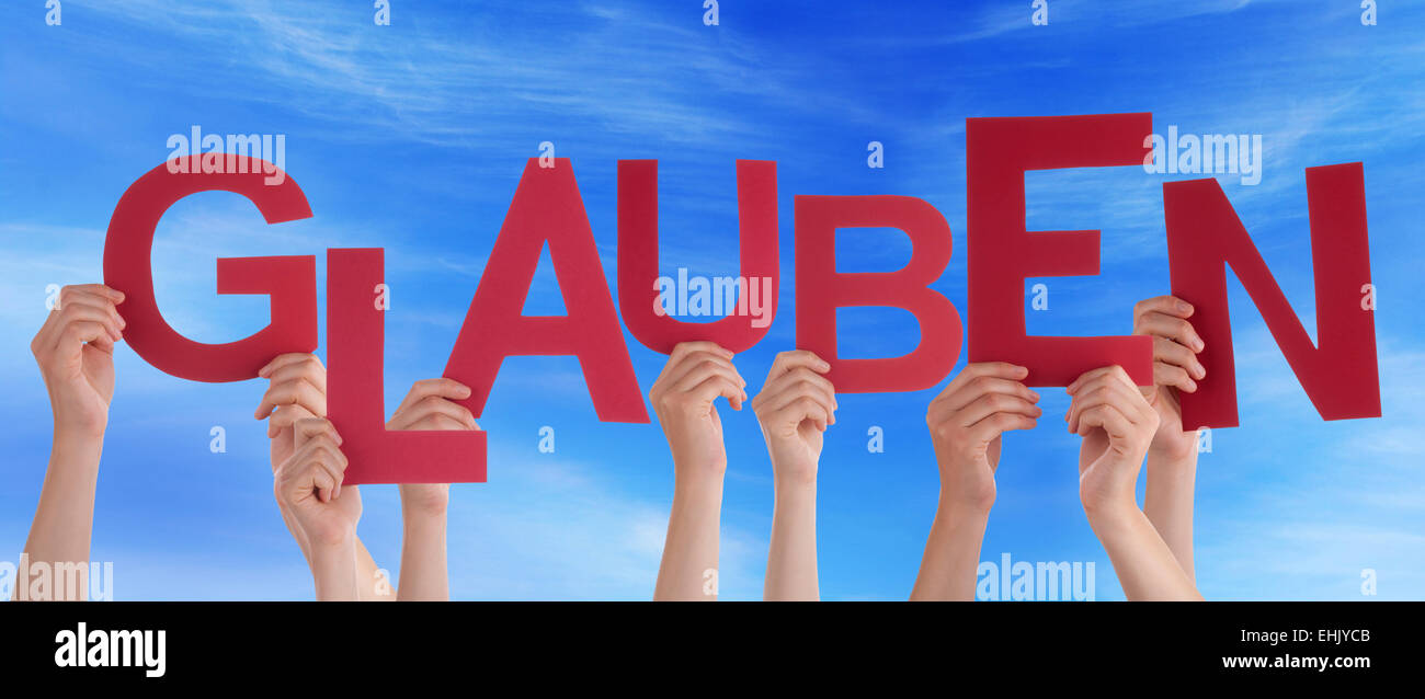 Many Caucasian People And Hands Holding Red Letters Or Characters Building The German Word Glauben Which Means Believe On Blue S Stock Photo