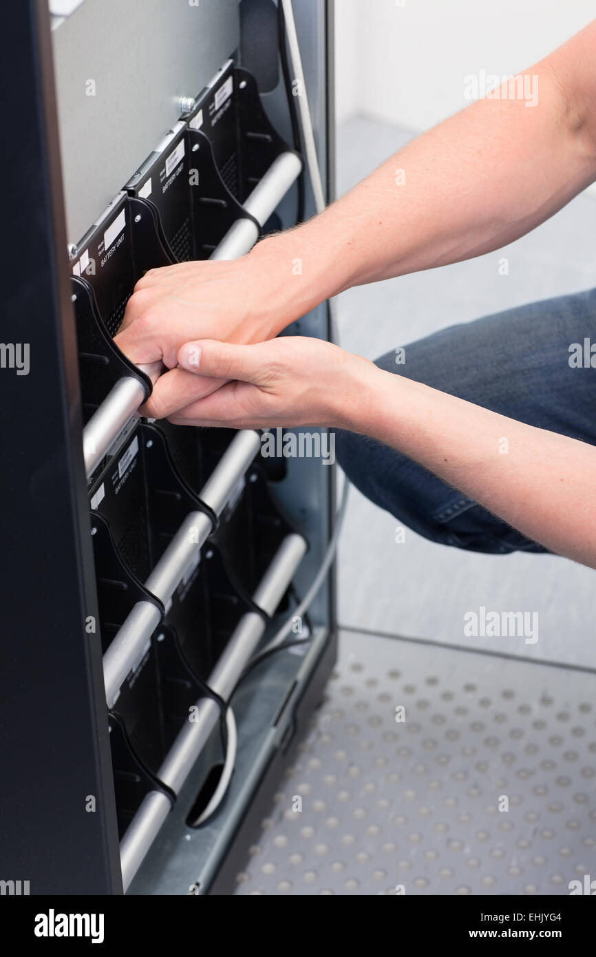 IT Engineer/ Consultant maintain a large UPS / Uninterrupted Power Supply in a datacenter. Stock Photo