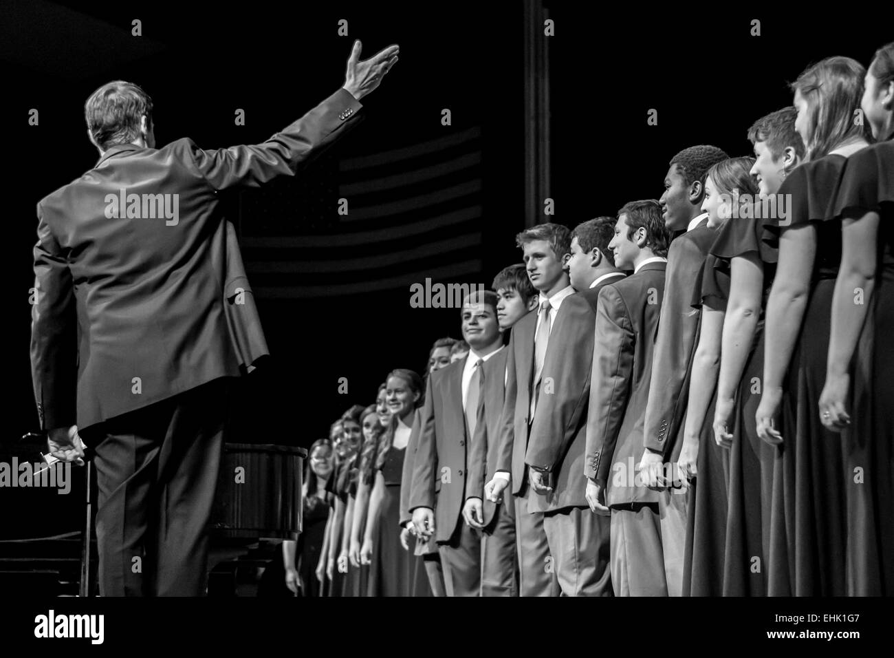 Choir Conductor Presents his an accomplished crowd after a winter choral presentation. Stock Photo