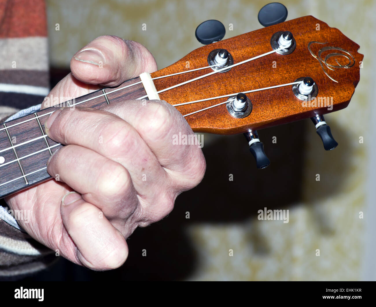 Hand on ukulele neck Stock Photo - Alamy