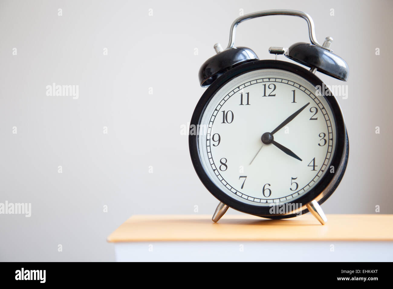 Alarm clock on the book Stock Photo Alamy