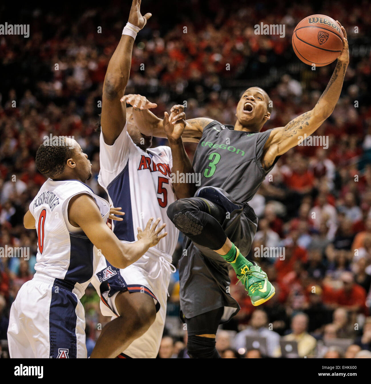 Las Vegas, NV, USA. 14th Mar, 2015. Oregon G # 3 Joseph Young tries to take the baseline tries to slam dunk over Arizona # 5 Stanley Johnson and # 0 Parker Jackson-Cartwright during NCAA Pac 12 Men's Basketball Tournament between Arizona Wildcats and Oregon Ducks 52-80 lost at MGM Grand Garden Arena Las Vegas, NV. Credit:  csm/Alamy Live News Stock Photo