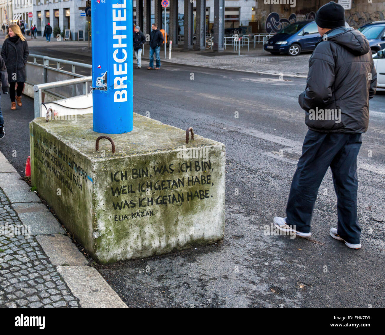 Concrete block supporting blue water drainage pipe inscribed with