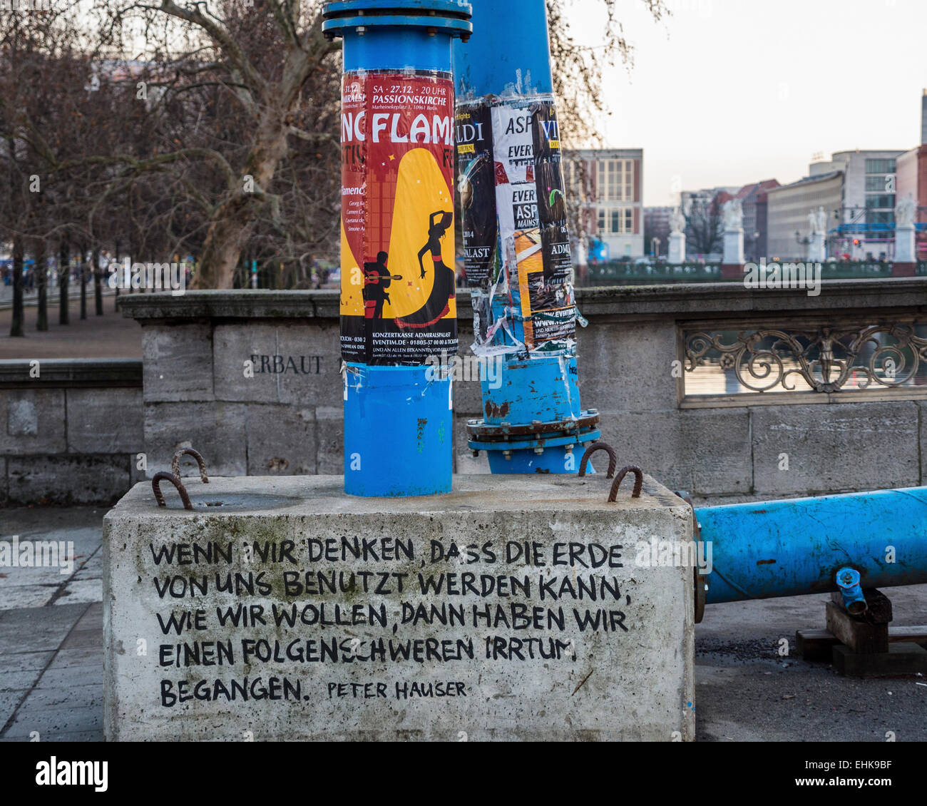 Concrete block supporting blue water drainage pipe inscribed with
