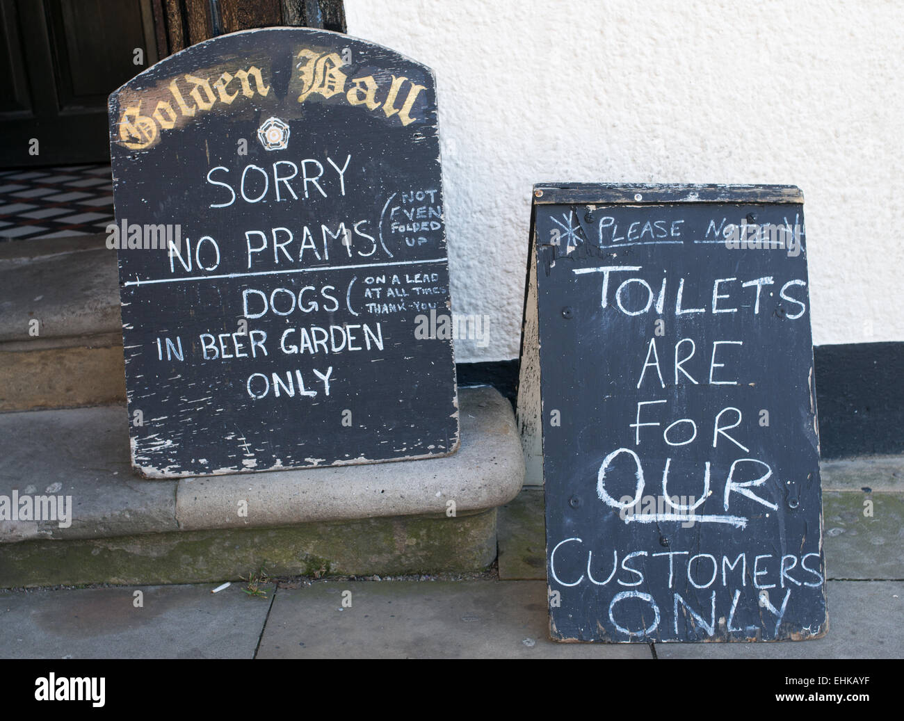 Unwelcoming signs outside the Golden Ball pub in Scarborough, North Yorkshire, UK Stock Photo