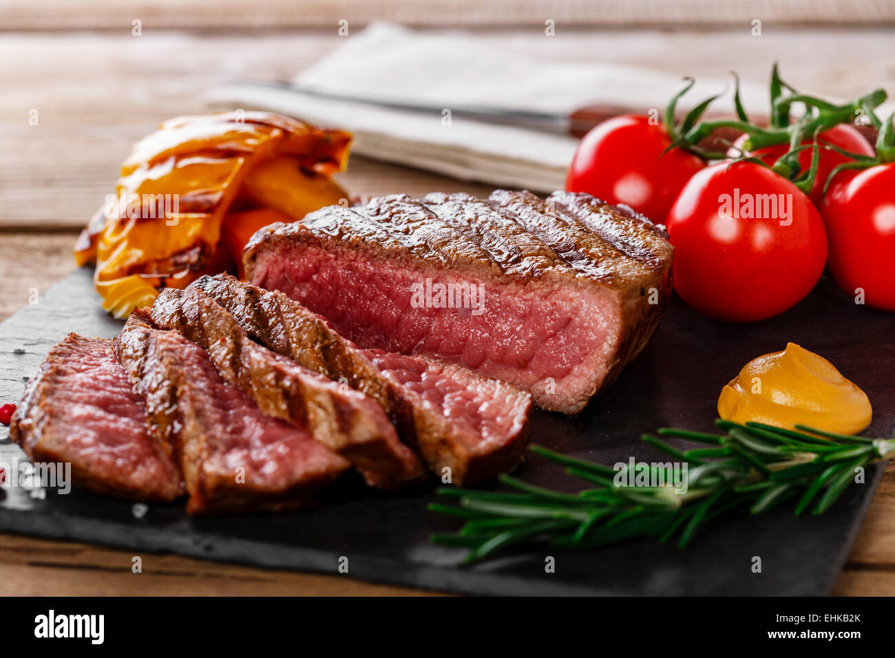 grilled beef steak rare sliced with vegetables Stock Photo Alamy