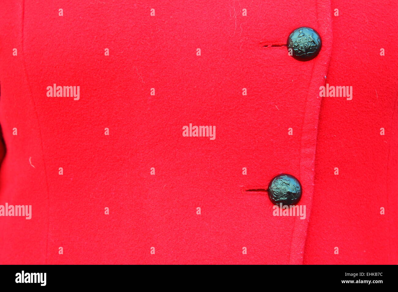on the red coat hanging black two buttons Stock Photo