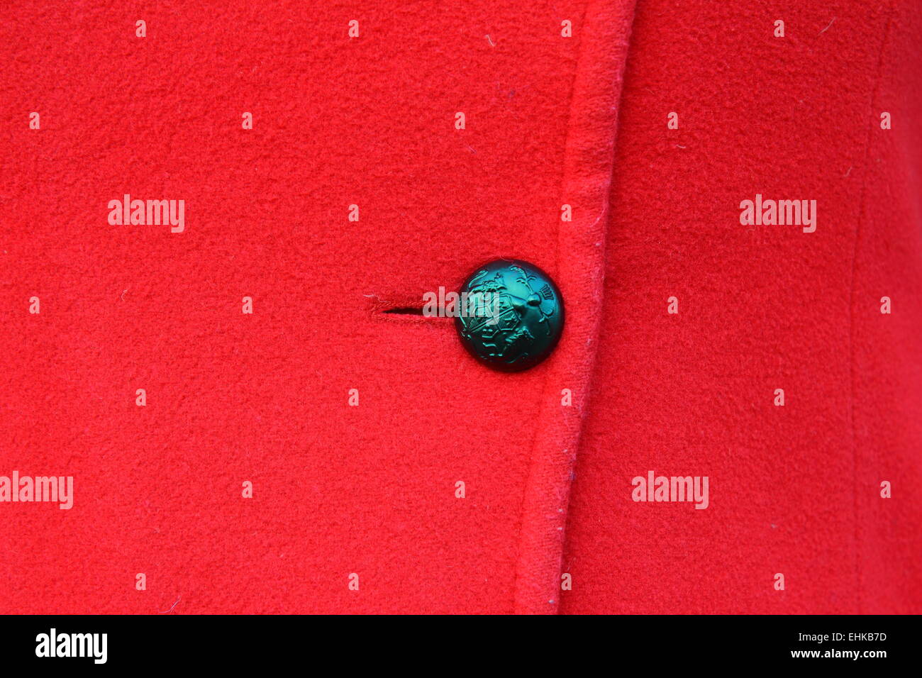 on a red coat hanging button black Stock Photo