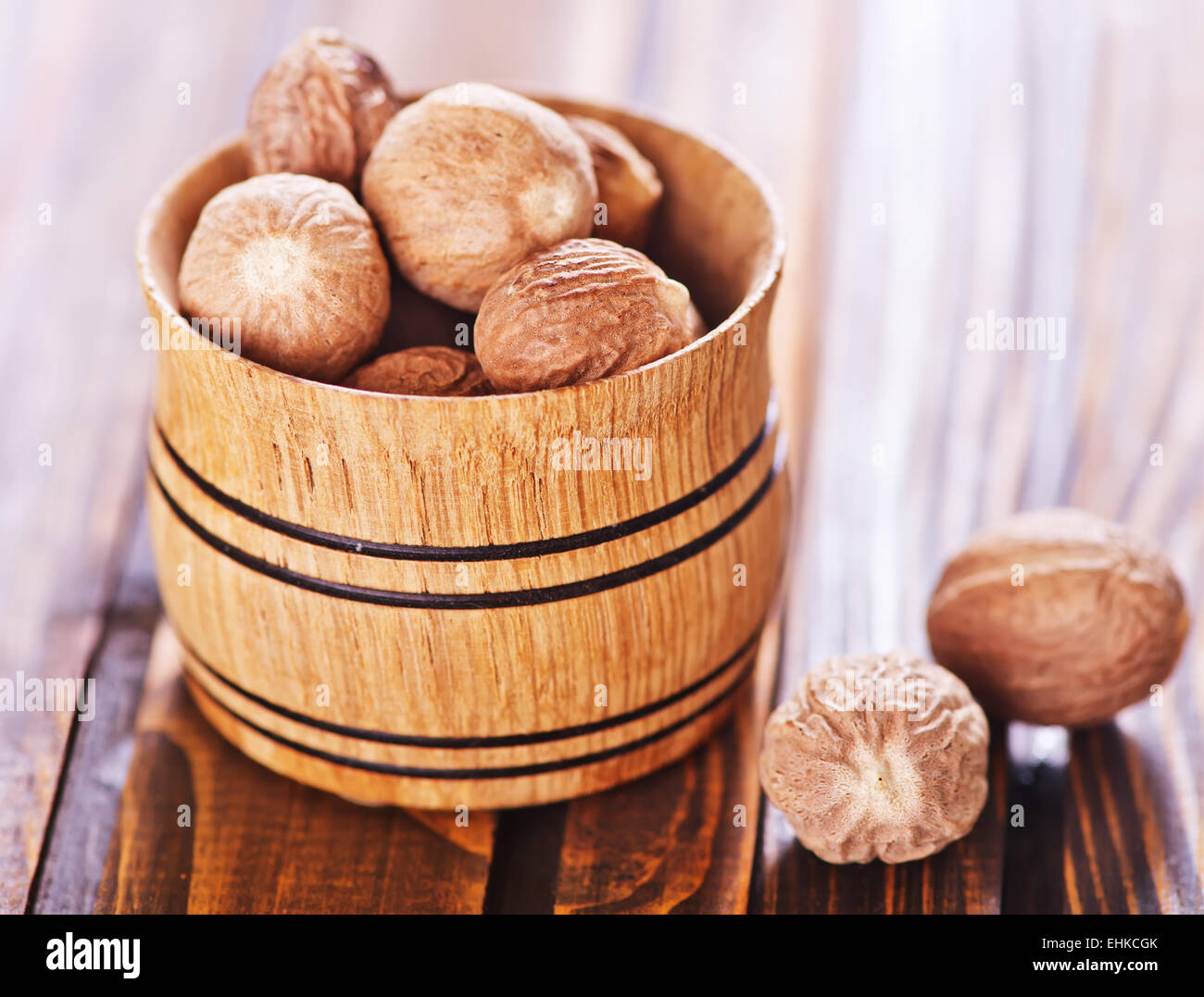 nutmeg in bowl and on a table Stock Photo Alamy