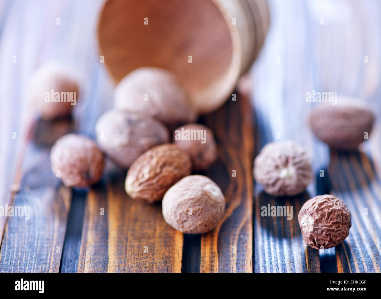 nutmeg in bowl and on a table Stock Photo Alamy
