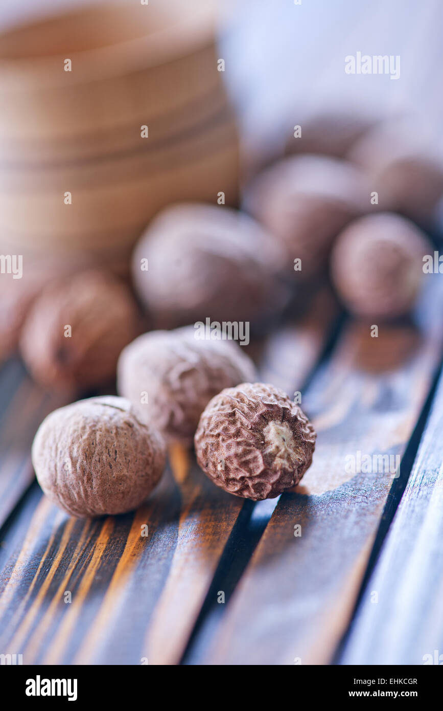 nutmeg in bowl and on a table Stock Photo Alamy