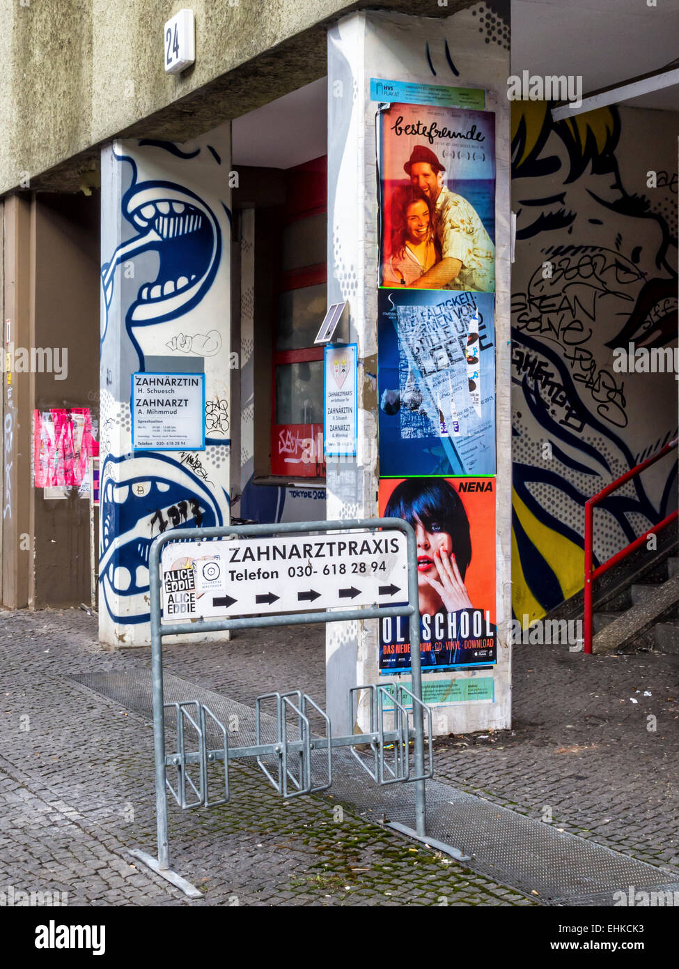Entrance to dental practice with artwork, graffiti Bicycle stand and posters in  Kreuzberg, Berlin Stock Photo