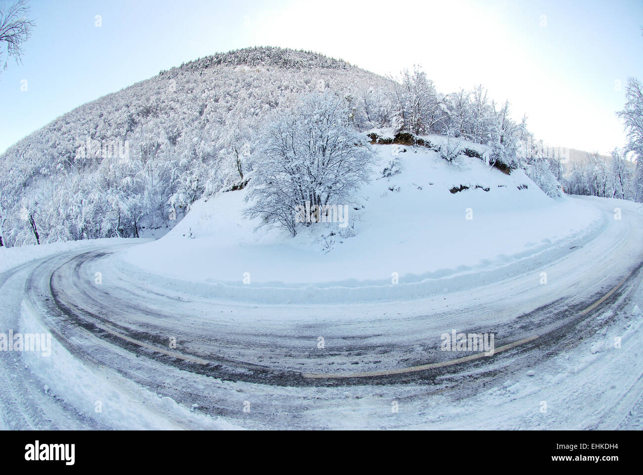 bend on road in snowy countryside Stock Photo