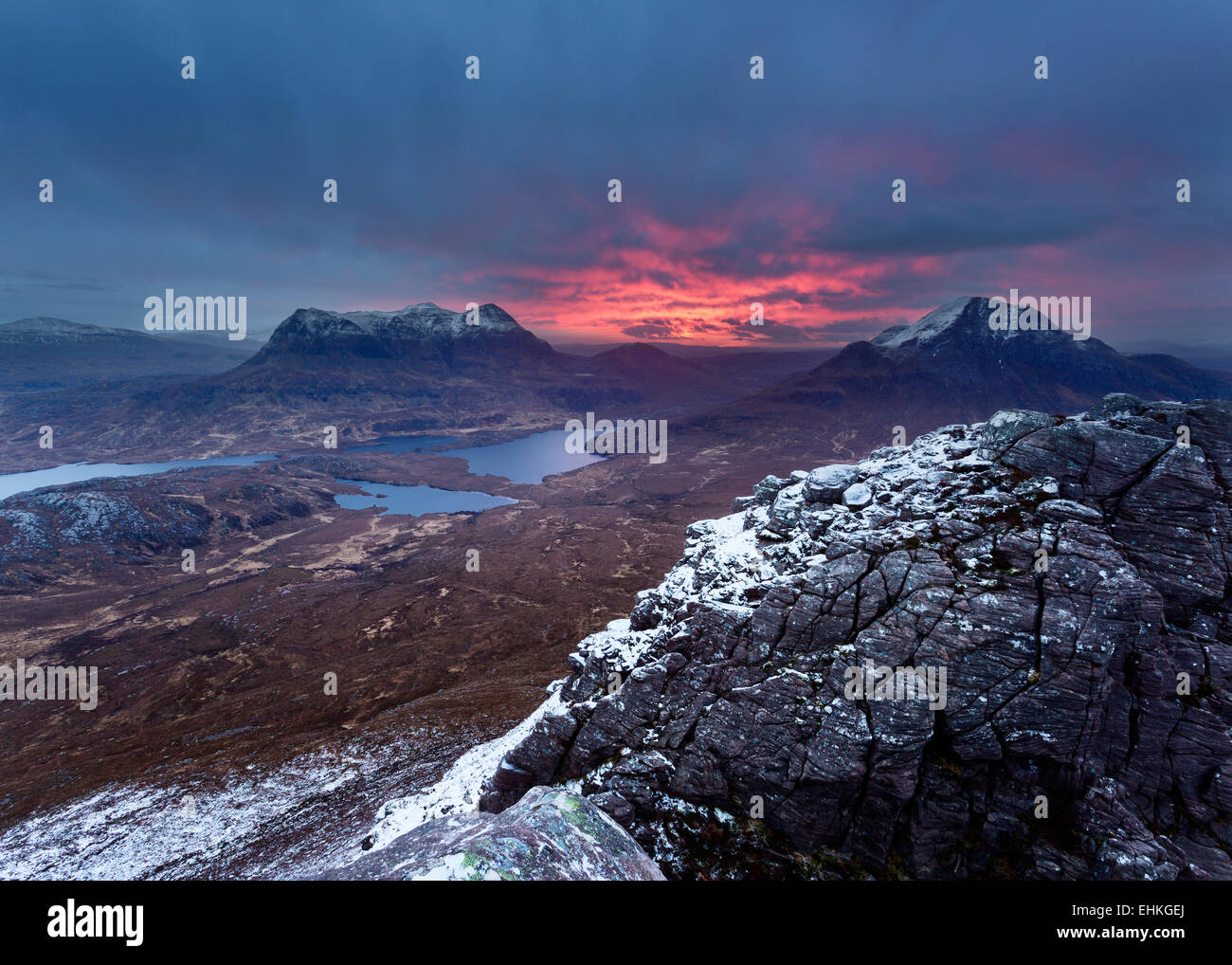 A spectacular interplay between warm and cool tones in the clouds at dawn, Stac Pollaidh. Cul Mor and Cul beag (right). Stock Photo