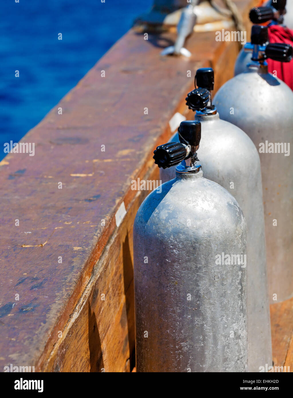 Three aluminum Compressed Air Tanks on Scuba Diving Boat Stock Photo