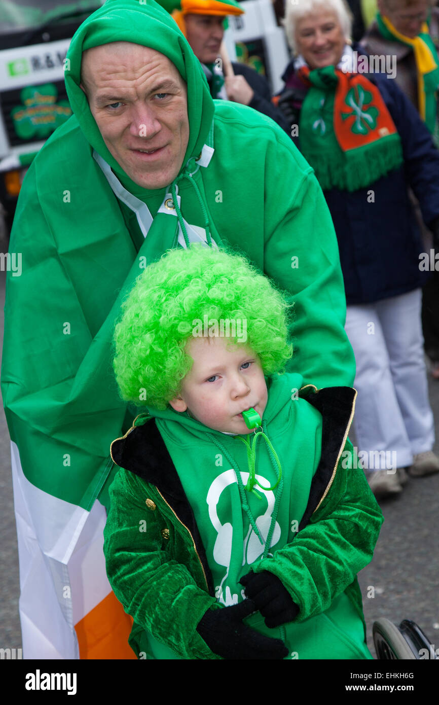 St. Patrick's Day wheelchair bound Daiton Berry Mellor 6 years old, a Spina bifida sufferer at the St Patrick's weekend Irish Festival. His dad has made a float as a Wheelbarrow full of gold coins and treasure.  The colourful procession set off from the Irish World Heritage Centre in Cheetham Hill before making its way to Albert Square.  Flag bearers representing the 32 counties in the Emerald Isle led the parade into the city centre, followed by floats from the city’s Irish associations. Stock Photo
