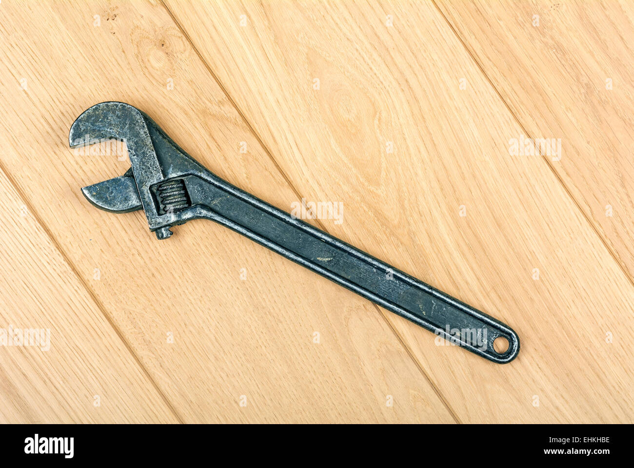 adjustable wrench embossed on the wooden floor Stock Photo