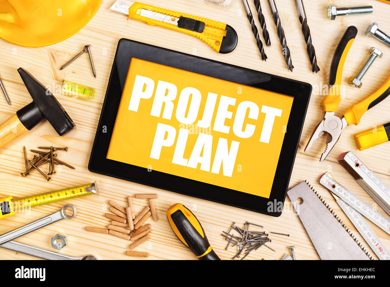 Project Plan For Home Redecoration Work with Digital Tablet and Assorted Woodwork and Carpentry Tools on Workshop Table Stock Photo