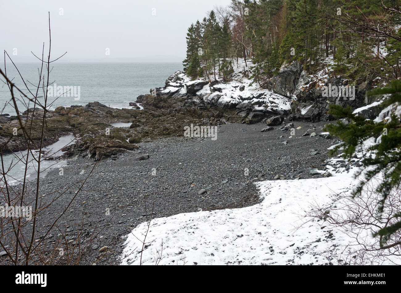 Snow, ice, and rain on the beach at Compass Harbor, Acadia National Park, Maine. Stock Photo