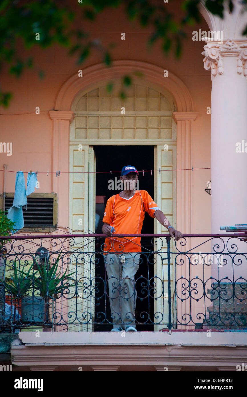 A man stands on a balcony, Havana, Cuba Stock Photo