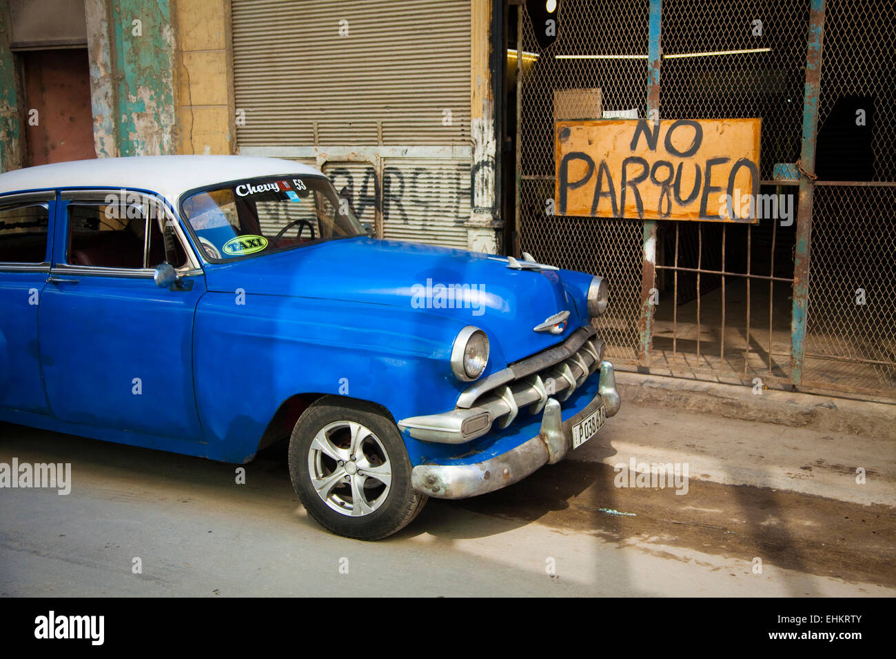 Classic car by no parking sign, Havana, Cuba Stock Photo